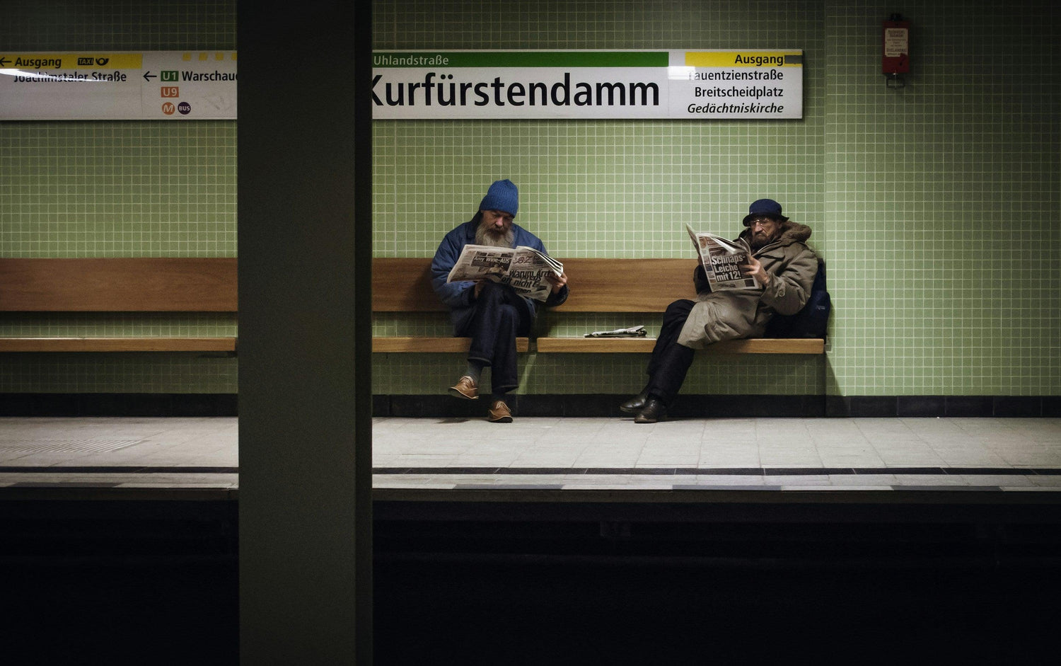 Foto mit wartenden Fahrgästen am Bahnhof Kurfürstendamm.