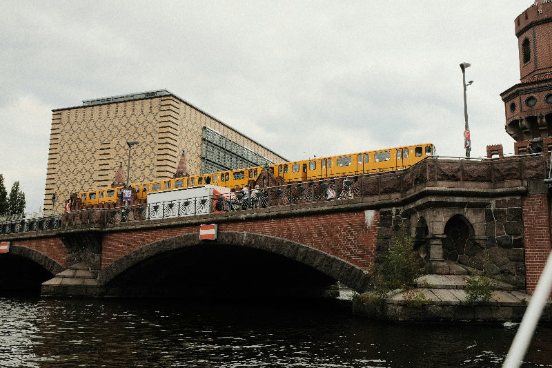 Bahnbrücke in Berlin-Friedrichshain mit fahrender U-Bahn.