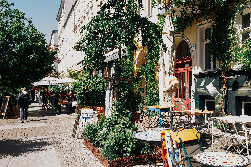 Foto vom Außebereich eines Restaurants im Berliner Kiez bei Sonnenschein, welches zugewachsen ist.