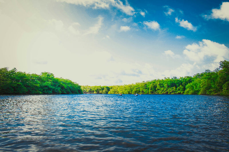 Foto von einem großen See bei Berlin mit Kajaks und blauem Himmel. 